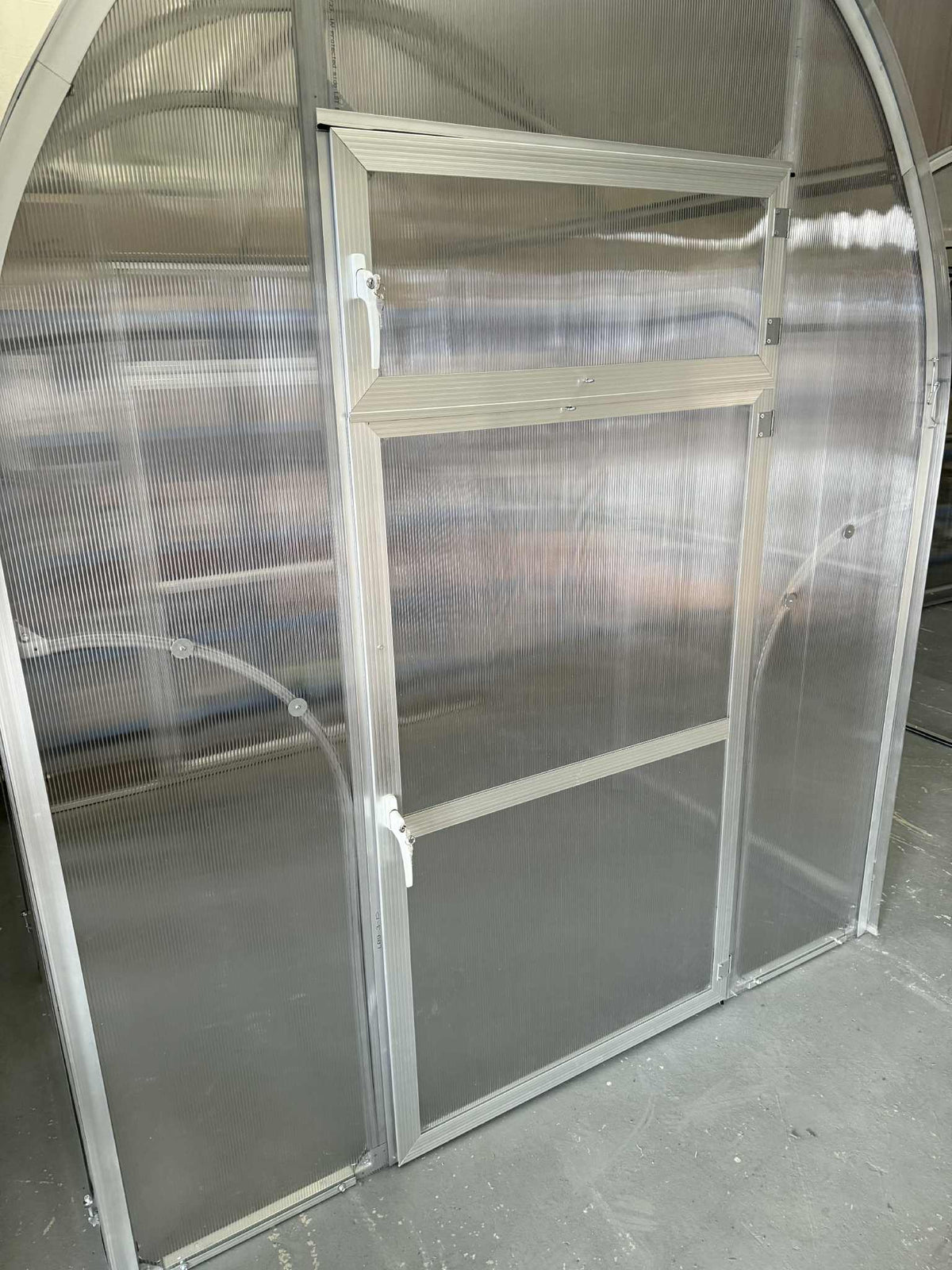 Partial view of a Sigma 200 (Gen III) greenhouse with a sliding door