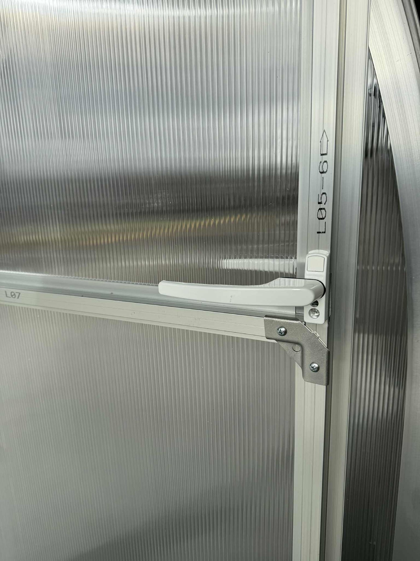 A detail of a door handle of a Sigma 300 (Gen III) greenhouse.