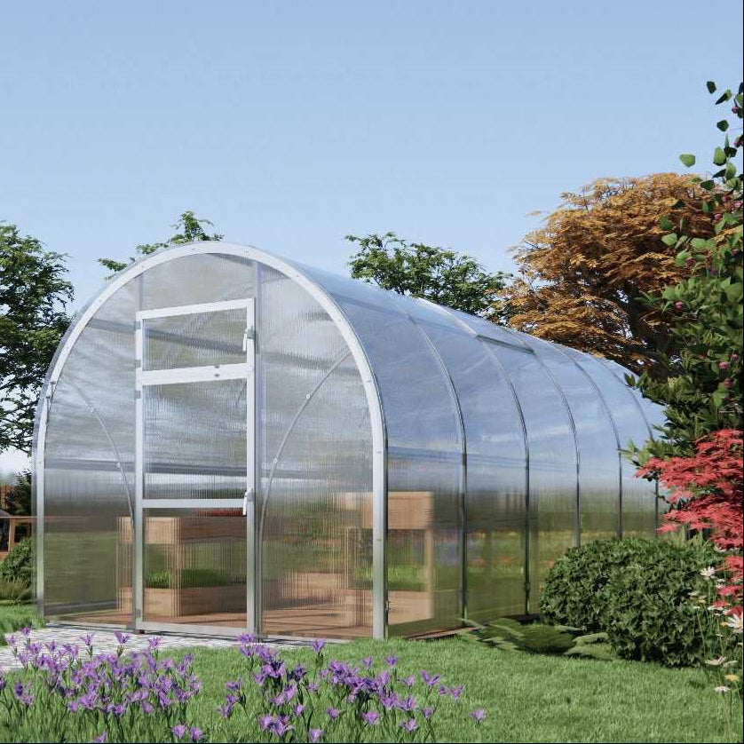 Sigma 250 (Gen III) greenhouse in a garden setting with trees and flowers