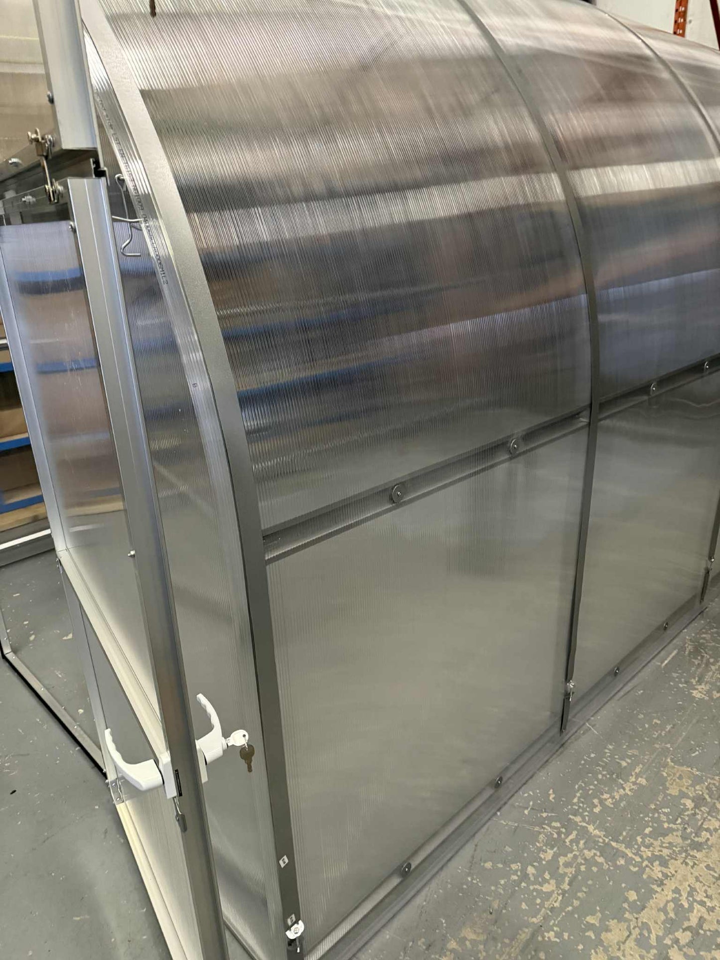 Roll of metal sheet on a Sigma 250 (Gen III) greenhouse with a textured background