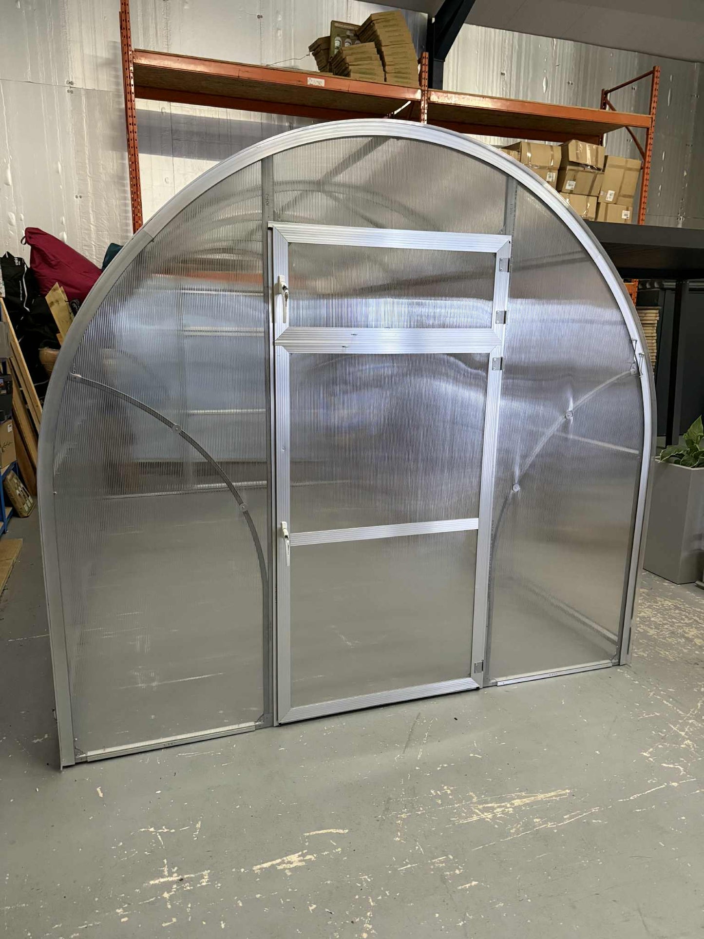 Sigma 250 (Gen III) greenhouse with a sliding door in an indoor setting