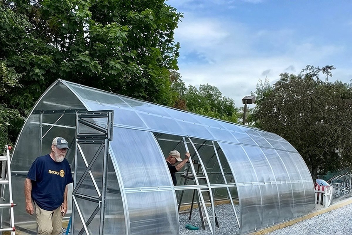 Assembling a greenhouse in cool fall weather
