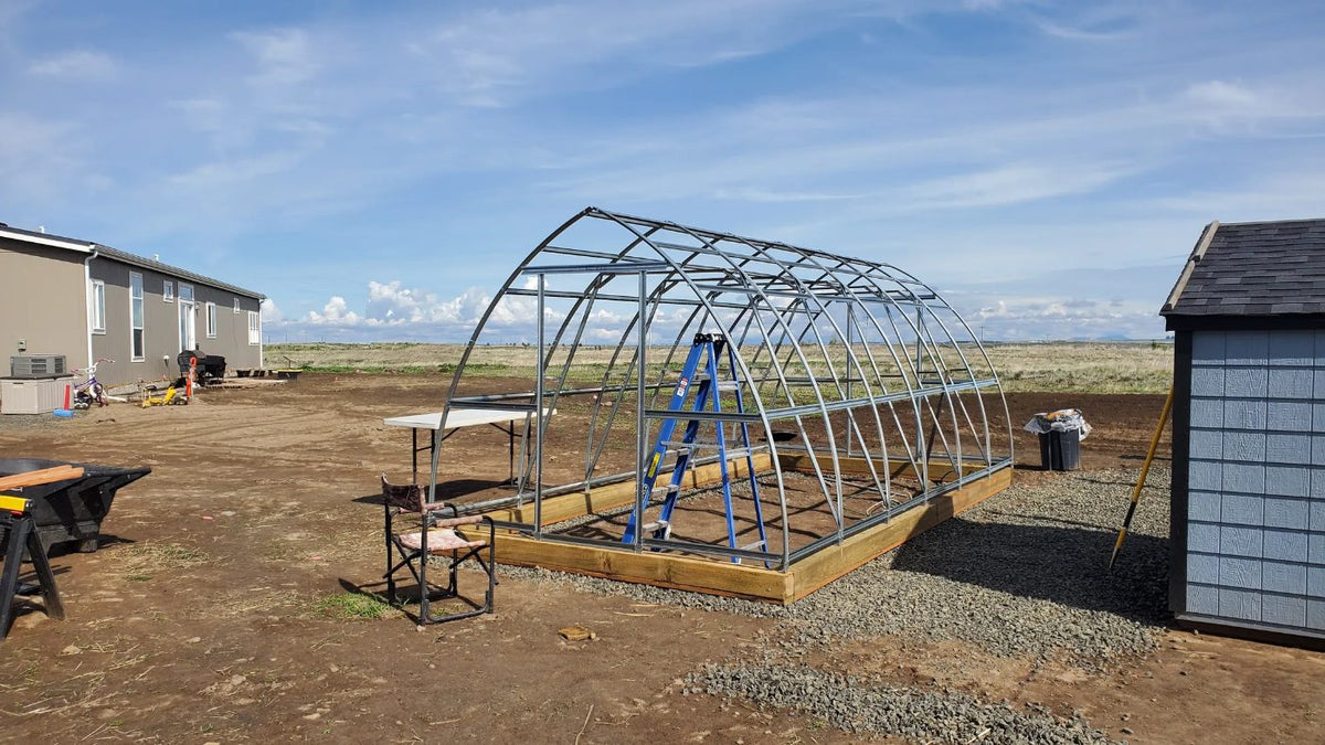 Greenhouse frame on a timber base mid-build